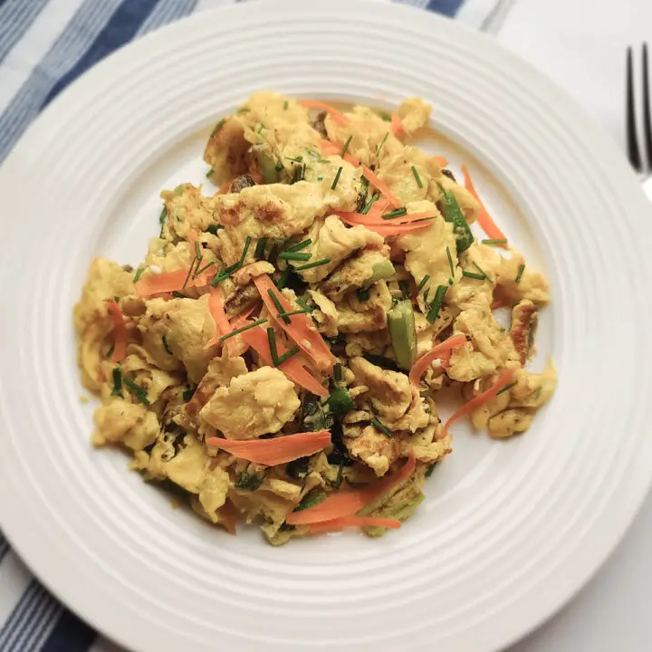 scrambled eggs primavera on a white plate