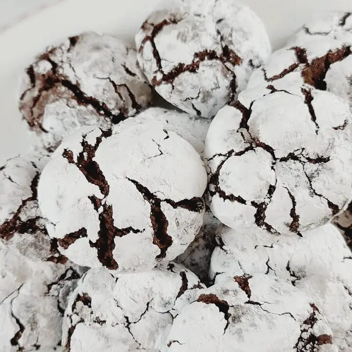 Stack of Chocolate Crinkle Cookies on a white plate